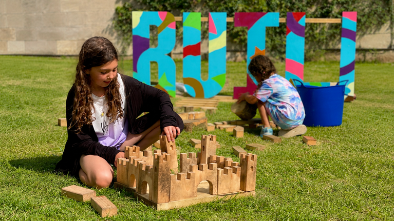 Child playing with building block summer of play Ilam park